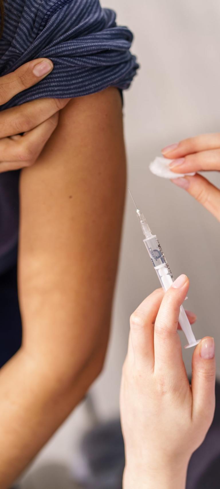A Woman Receiving An Injection From A Syringe At An Onsite Flu Clinic