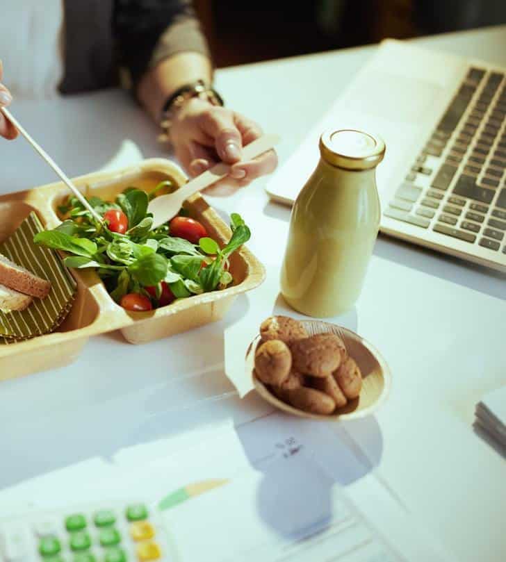 A Person Consuming A Salad Using A Fork And Knife For Nutrition Coaching
