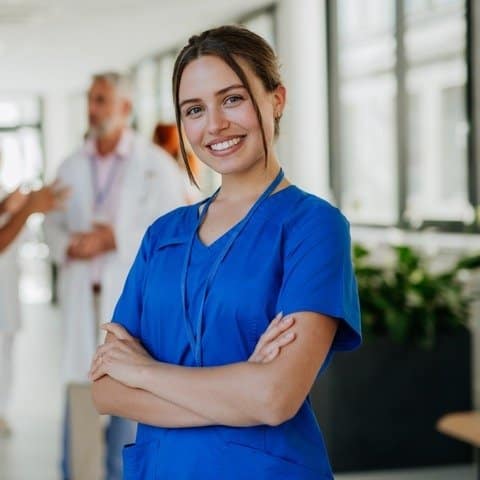 Female Healthcare Worker In Blue Attire As Part Of Medical Talent Management 