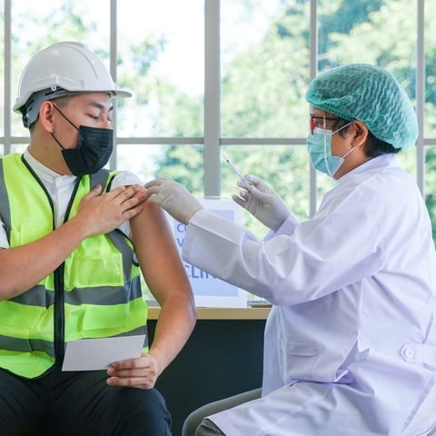 Healthcare Worker Vaccinating A Government Employee In A Public-Health Crisis Solution