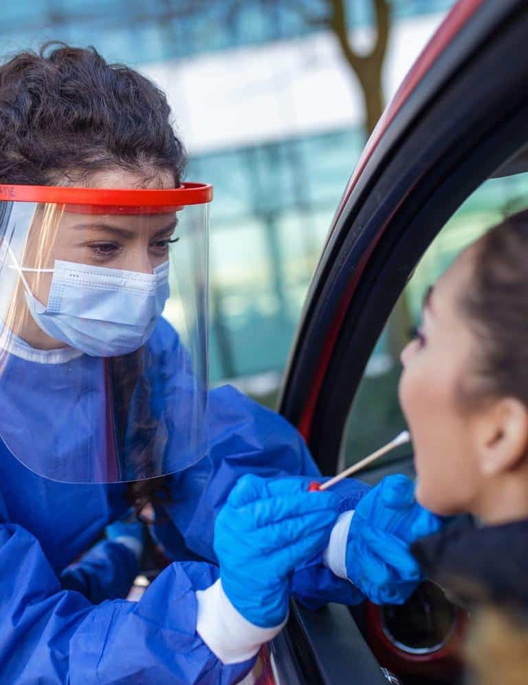 Healthcare Worker Swabbing A Woman In Car During Public Health Crisis