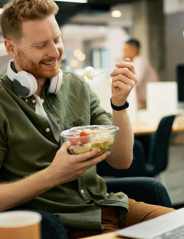 Man Enjoying A Fresh Salad With Nutrition Coaching