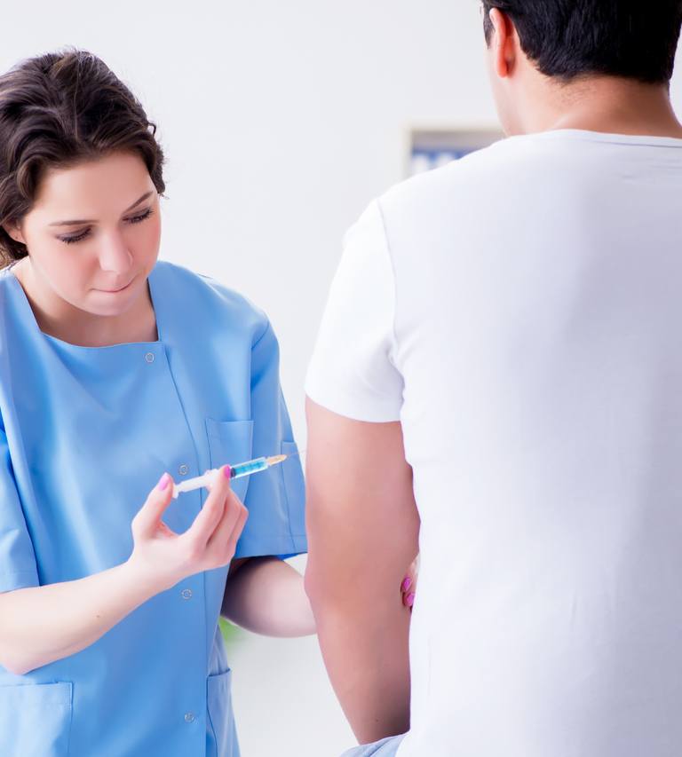 Medical Professional Administering A Workplace Wellness Injection To A Patient
