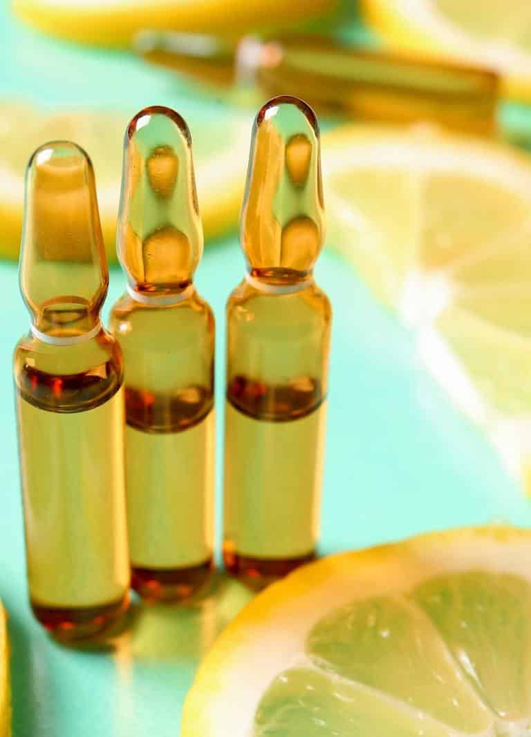 Three Bottles Of Vitamin C Oil With Lemons For Vitamin Injections